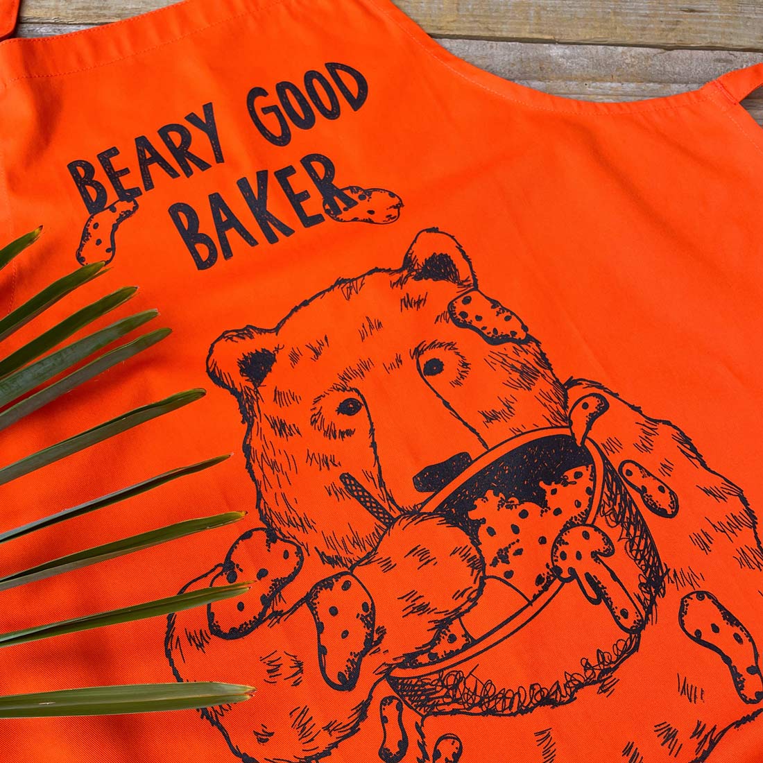 orange apron with baking bear