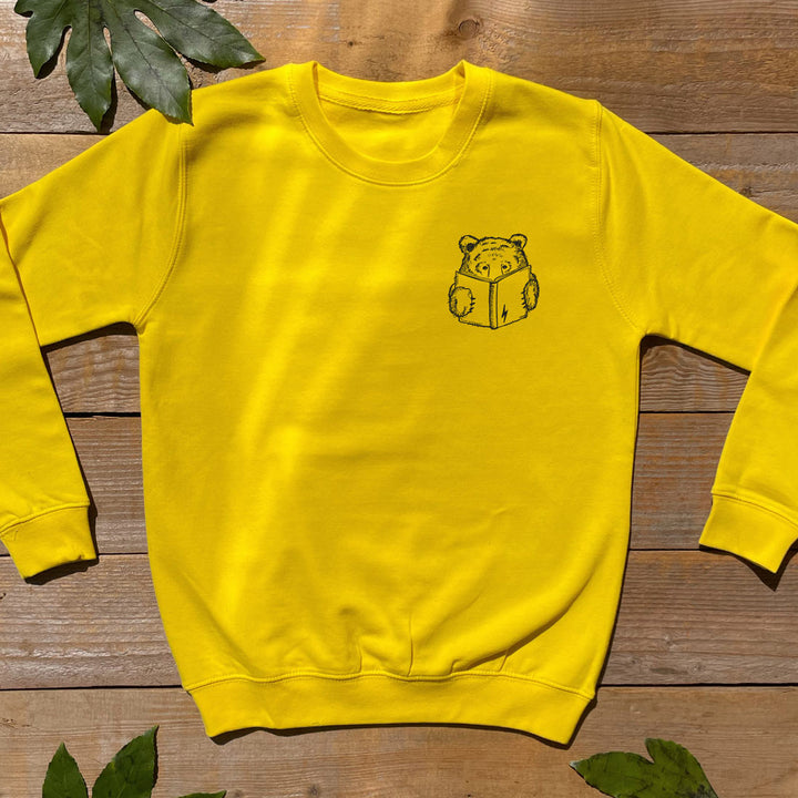 yellow kids jumper with bear reading a book