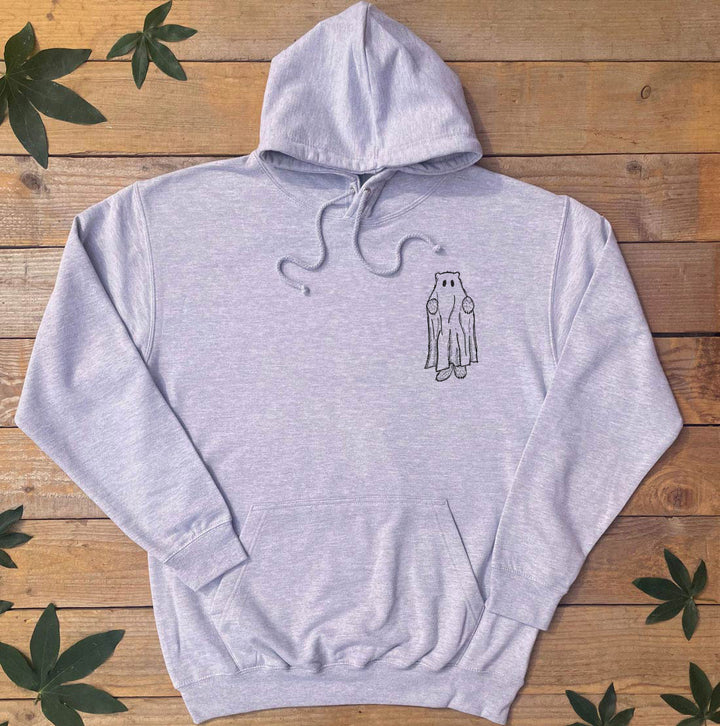 Gray hoodie with a small graphic on a wooden surface