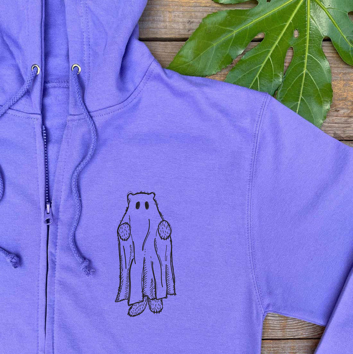 Purple hoodie with a bear graphic on a wooden surface with leaves