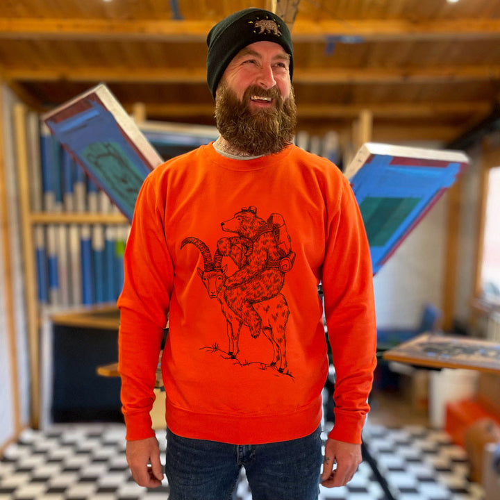 orange jumper with bear and goat design