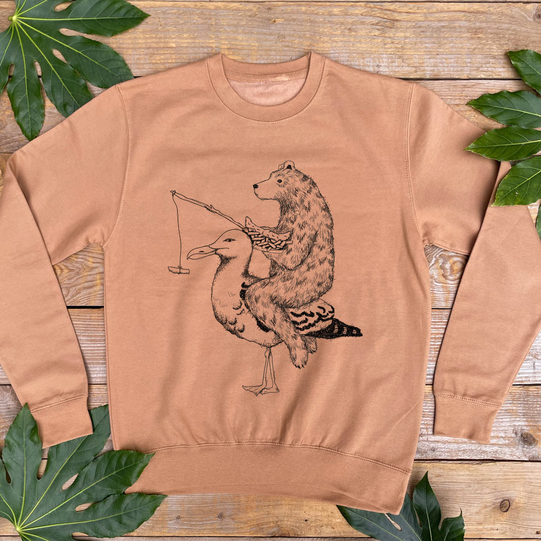 brown jumper with bear riding a seagull