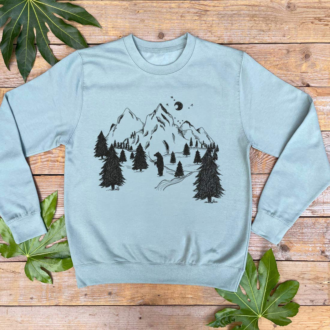 mint colour jumper with bear in the woodlands scene