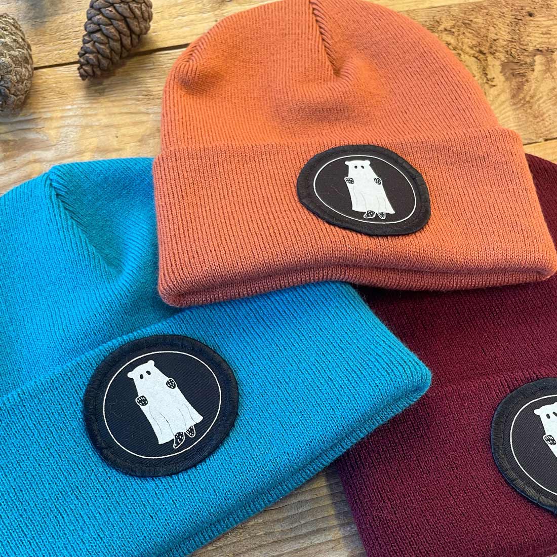 three beanies with bear patch