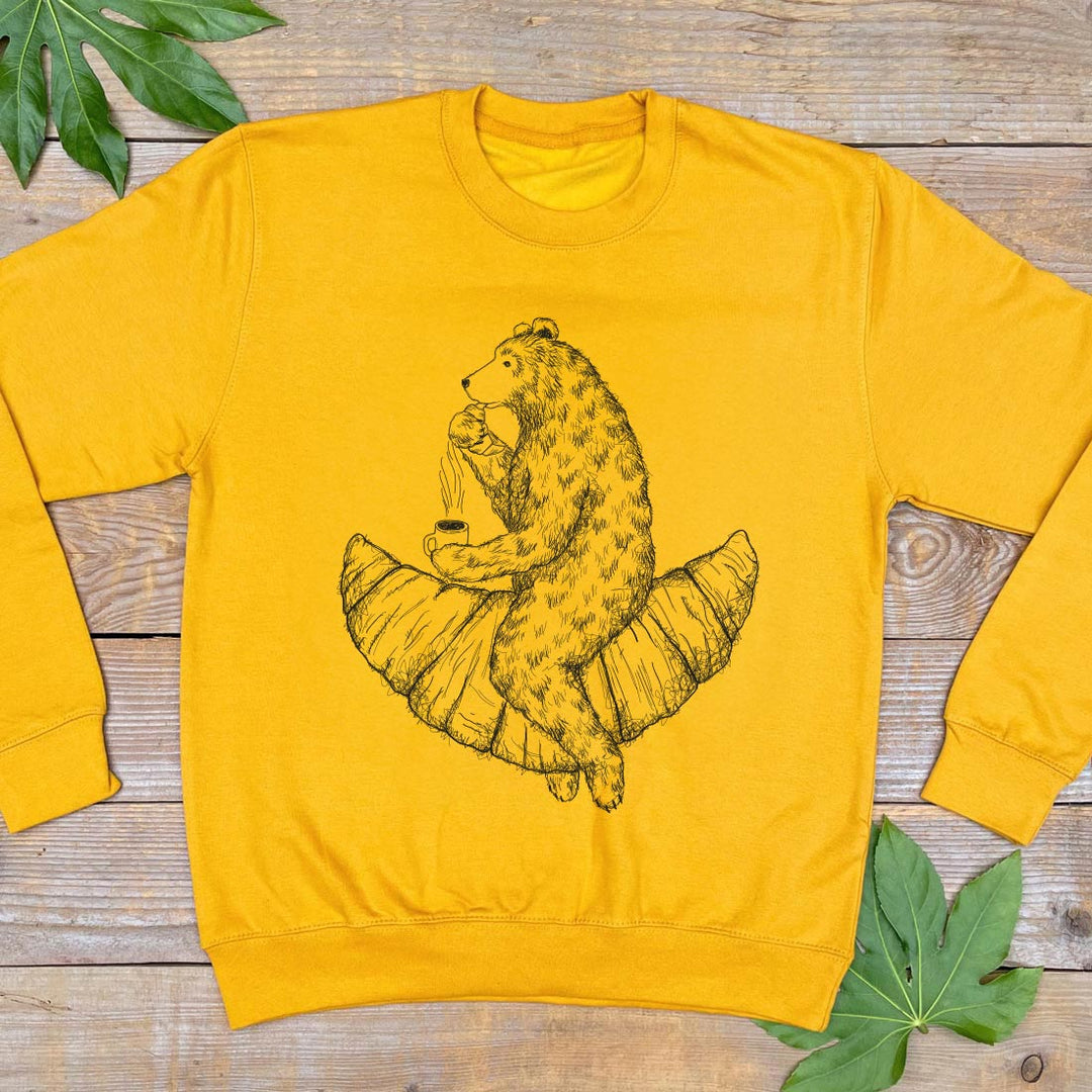 yellow jumper with bear riding a croissant design