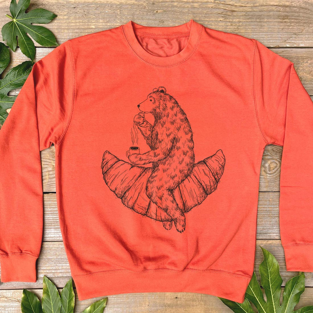 orange jumper with bear and croissant design