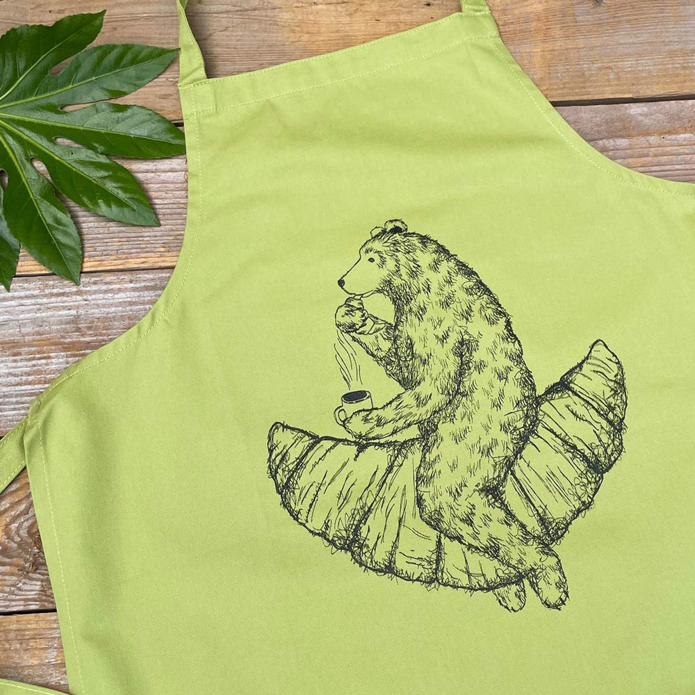 green apron with bear eating a croissant print