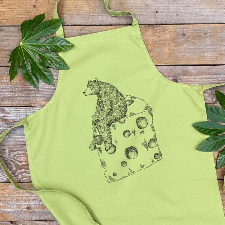 green apron with bear sat on cheese design
