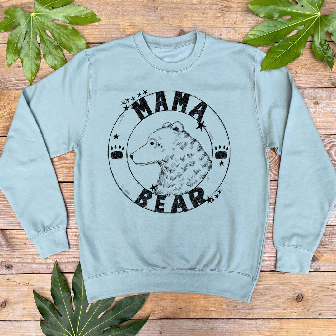 Mint Green sweatshirt with 'Mama Bear' graphic on a wooden surface with leaves.