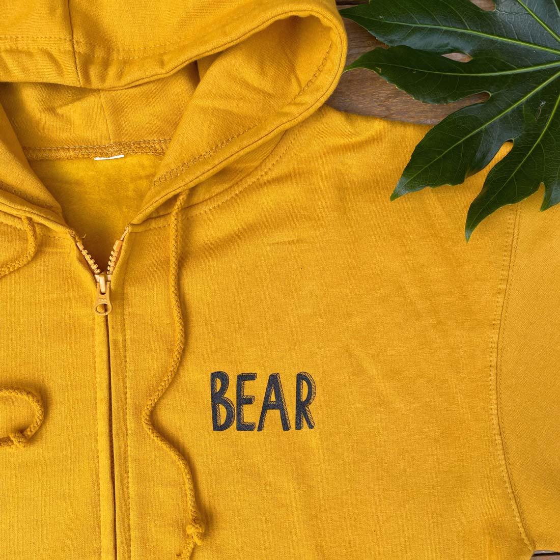 mustard hoodie with bear text