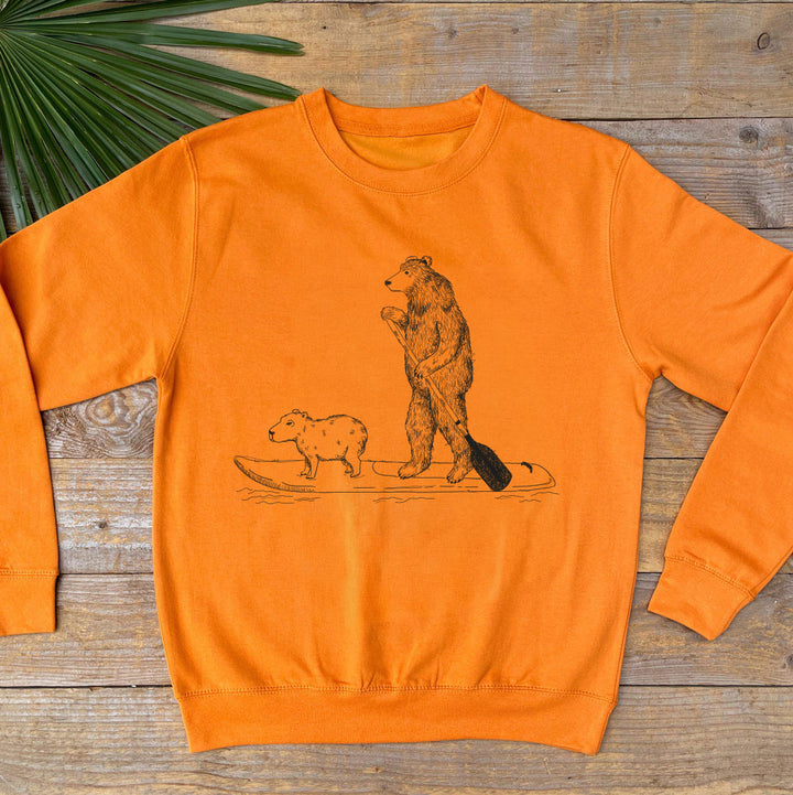 orange jumper with bear paddle boarding
