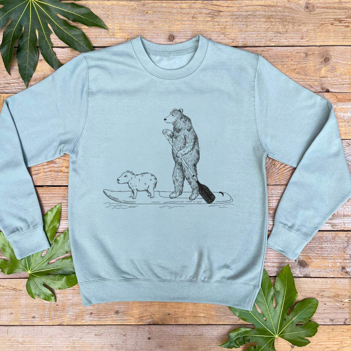 mint colour jumper with bear on paddle board