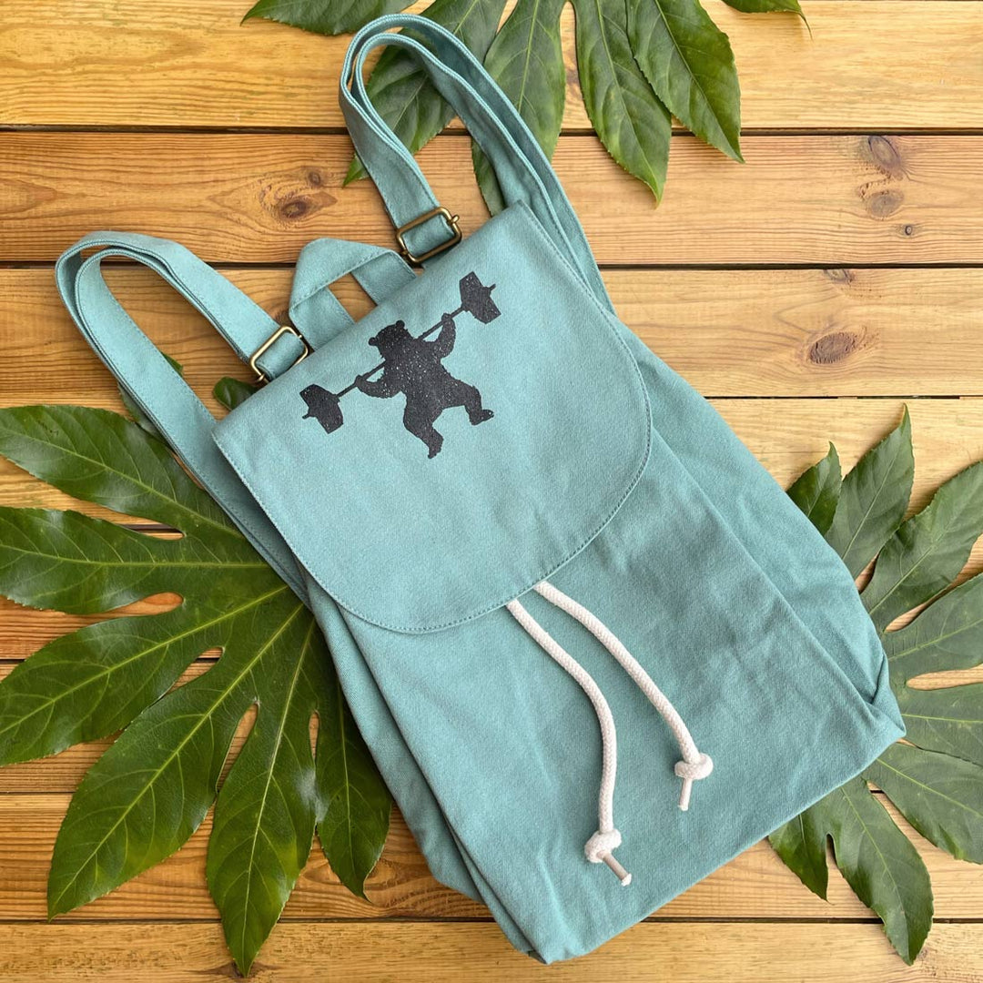 greeny blue baclpack with weightlifting bear