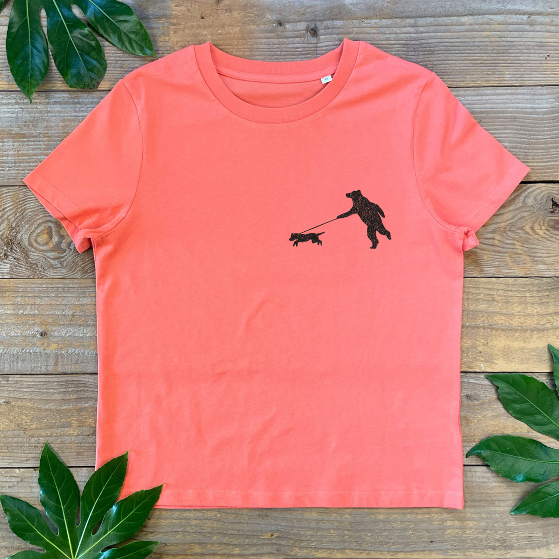 orange tee with bear walking dog