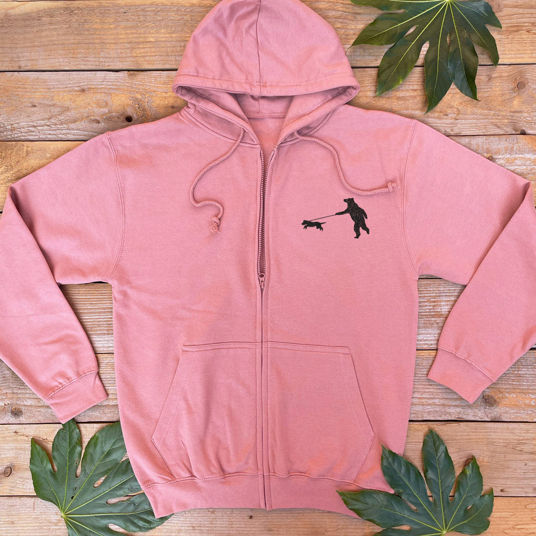 dusky pink hoodie with a bear walking a dog print on the pocket