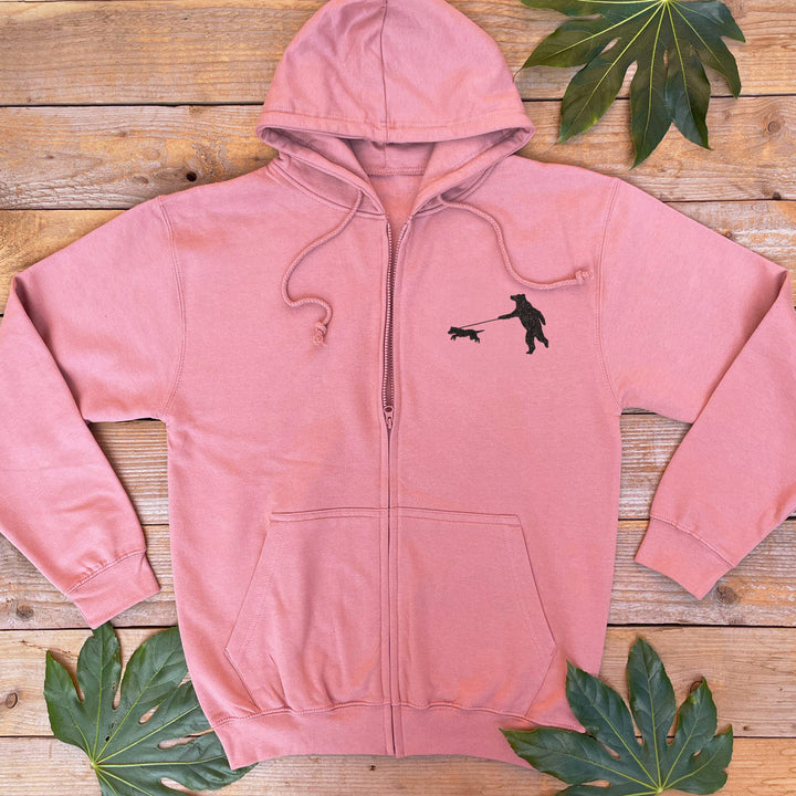 dusky pink hoodie with a bear walking a dog print on the pocket