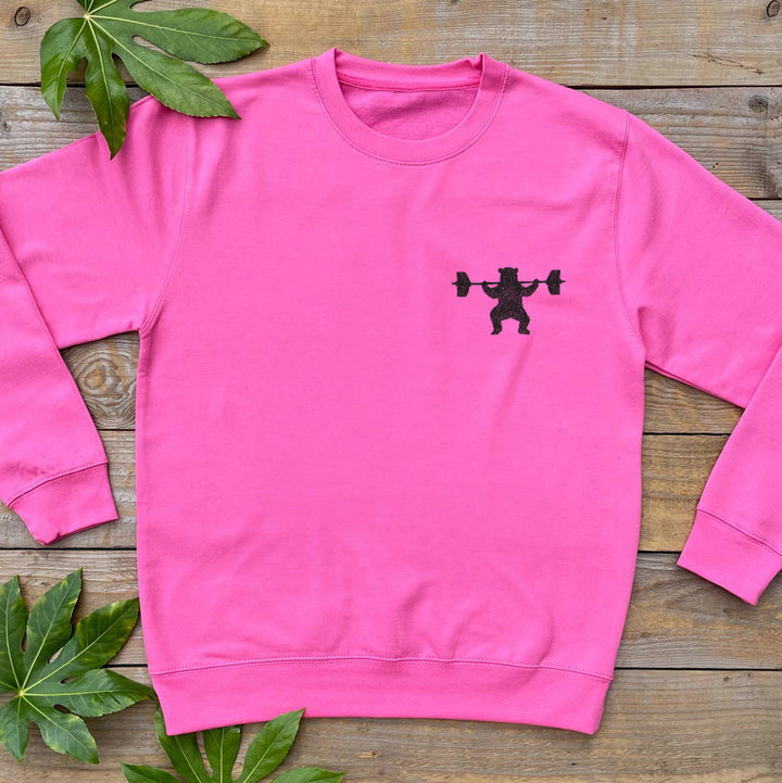 pink jumper with bear lifting weights